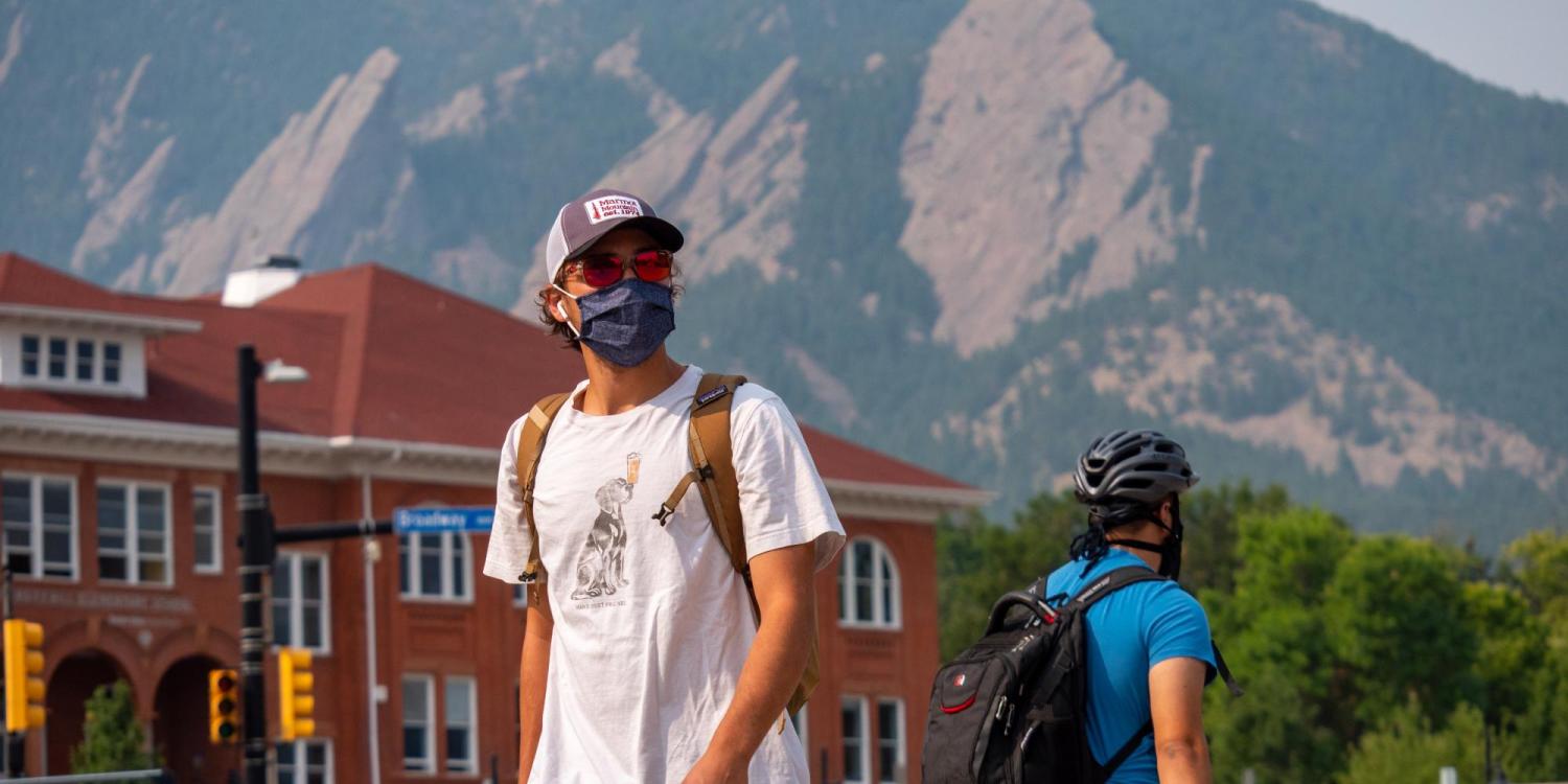 student wearing mask on campus outside 