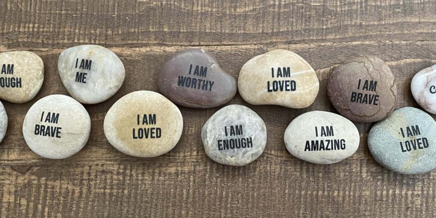 Image of rocks displaying messages of self-affirmation.
