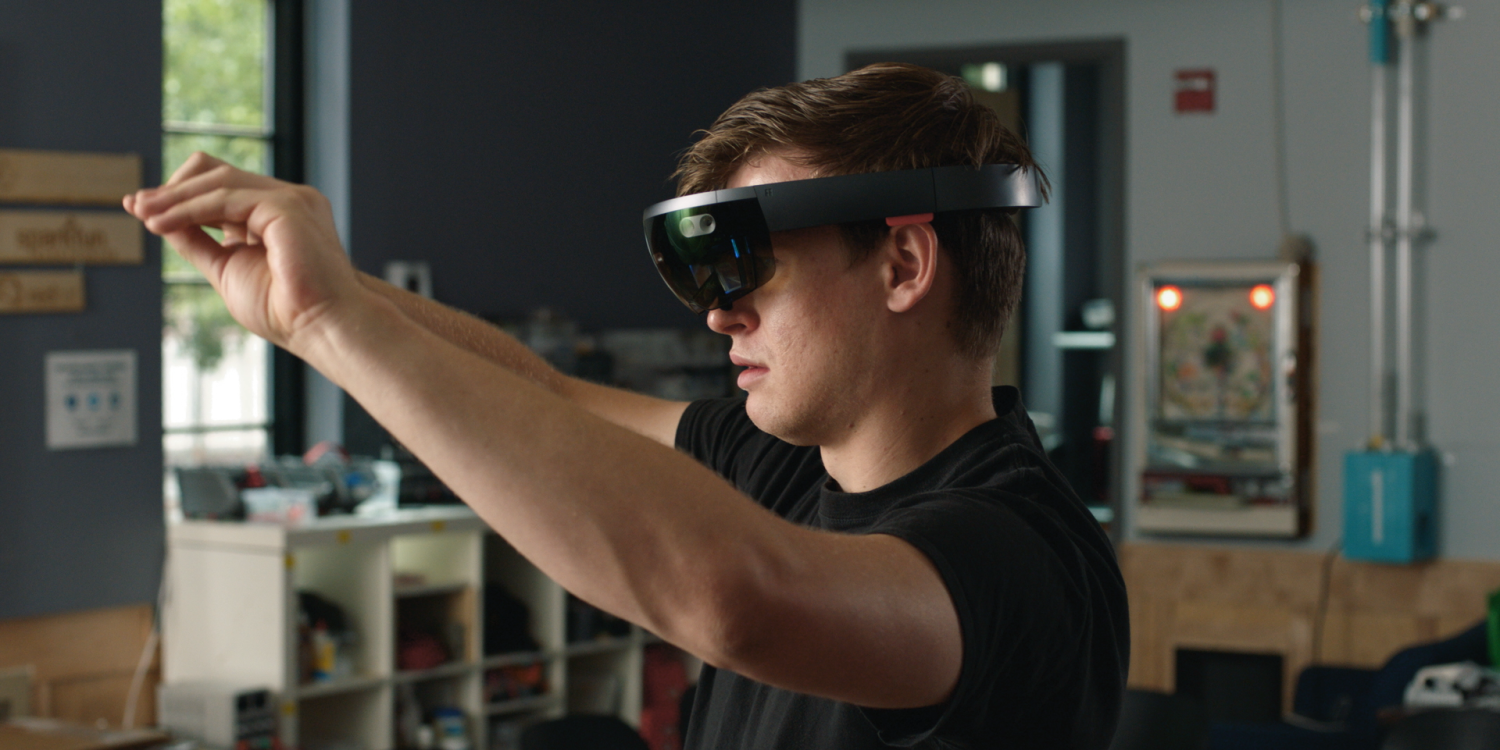 A young man appears with virtual reality glasses on.