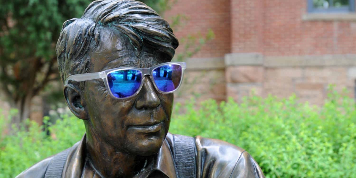 Robert Frost statue wearing sunglasses