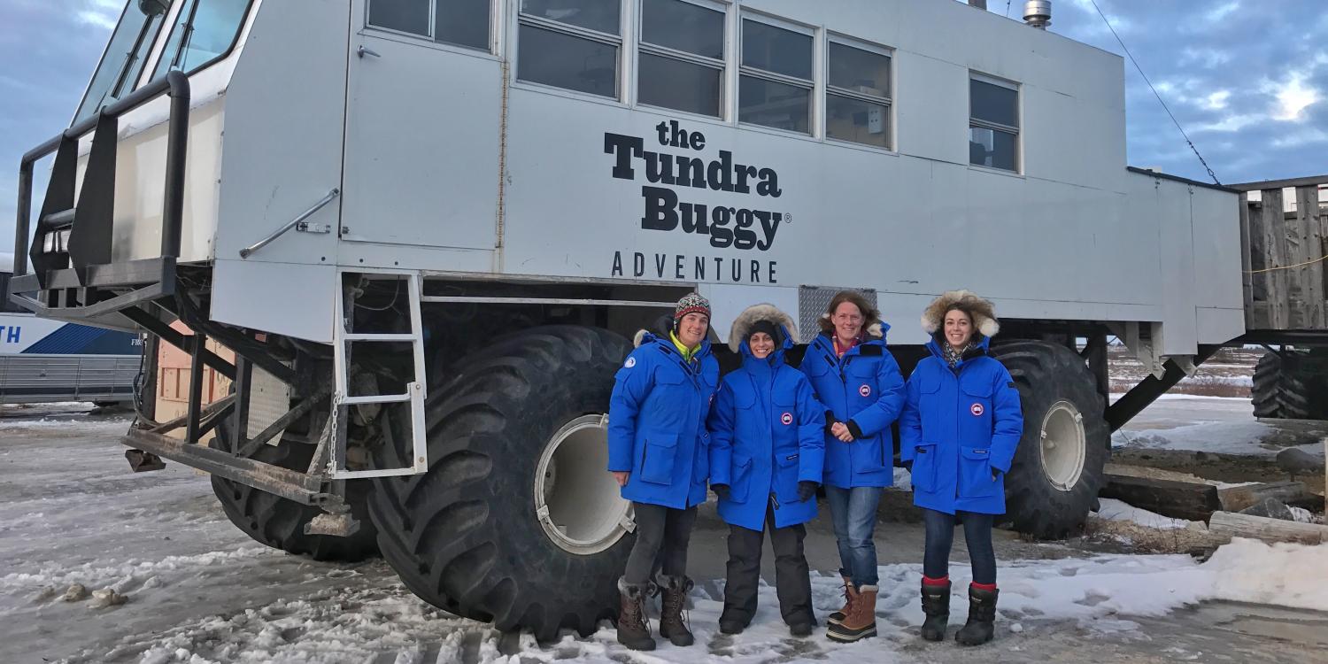 Students pose in front of the Arctic Tundra Buggy