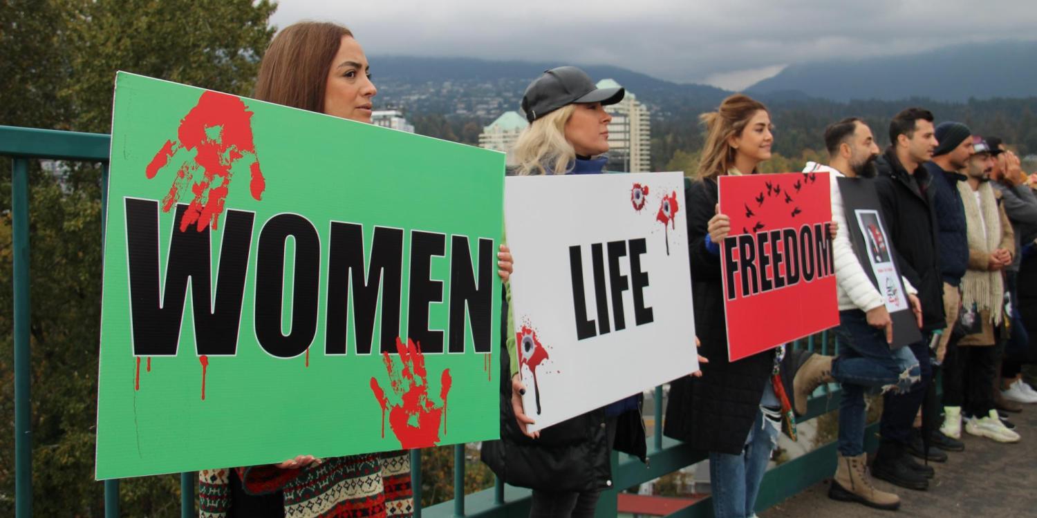 Women, Life, Freedom signs held by protestors