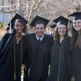 Graduates stand in Norlin Quad, celebrating their commencement