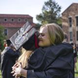 Two graduating Buffs share a hug