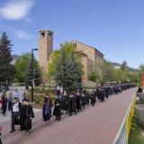 Commencement procession in front of the Eaton Humanities building