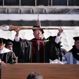 Commencement marshal Bud Coleman lowers the staff to signal the start of the ceremony