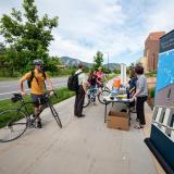 Cyclists check in at the Biofrontiers station by the Jennie Smoly Caruthers Biotechnology Building on the CU Boulder East Campus during the 2019 Bike to Work Day in Boulder. (Photo by Glenn Asakawa/University of Colorado)