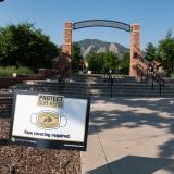 A Protect Your Herd sign seen in front of Farrand Field