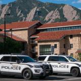 Two police vehicles are parked on the CU Boulder campus. (Patrick Campbell)