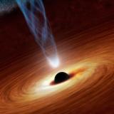 Matter swirls around a central black hole as it emits a bright jet