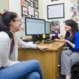 Academic advisor speaks with a student in her office