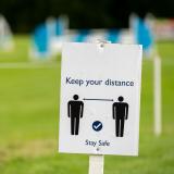 a sign that says keep your distance