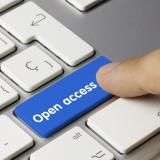 A person pressing a keyboard button that says "open access"