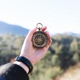 Woman holds out compass to determine direction