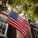 American flag in front of an old brick home