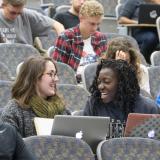 Students talk, sit in auditorium