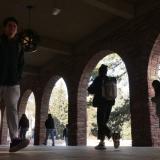 students walking under a breezeway on campus