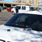 Police officer stands next to white van