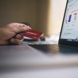 Person holding credit card to make purchase online