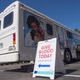 Bonfils Blood Center bus with 'Give Blood Today' sign