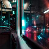 Looking through bus window at night