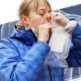 A volunteer blowing into a breathalyzer