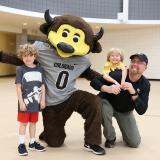 CU employee and children pose for a photo with Chip the Buffalo at the Rec Center