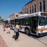 students wait to board Buff Bus