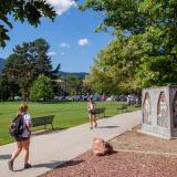 Campus community members walking outside on campus