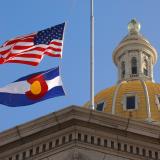 Denver capitol building with American flag and Colorado state flag