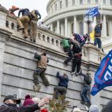 Rioters scale a wall at the Capitol on January 6, 2021. (Credit: CC image via Flickr)