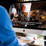 Man watches captioned video on computer