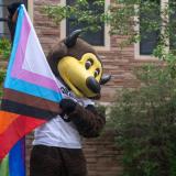 Chip holding up a pride flag