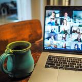 coffee mug and Zoom conference on laptop