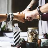 Group huddle with hands outstretched