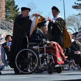 Gerald One Feather receives his honorary degree during the 2013 spring commencement. (Photo by Casey A. Cass/University of Colorado)