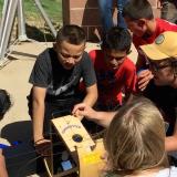 CU Boulder astronomy and physics student Sam Strabala searches for sunspots with middle schoolers in Keenesburg, Colorado as part of a science outreach program.