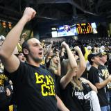 Fans cheer on the men's basketball team