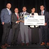 The winning team holds the trophy and prize check at NAIOP's Rocky Mountain Real Estate Challenge