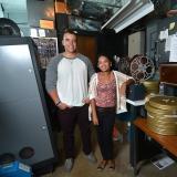 Students Adam Elbeck and Melina Dabney in Muenzinger Auditorium's projector room