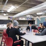 Students chat over coffee at the Idea Forge