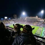 Fans wearing buffalo hats watch the game from the Champion Center