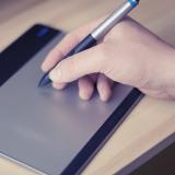 Man gives electronic signature with digital stylus