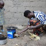 A family in Rwanda using a wood-burning cookstove as part of a large-scale delivery program