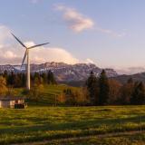 windmill on farm with mountains behind