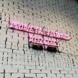 neon sign that says 'People fail forward to success'