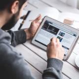 Man reads news on tablet