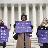 Demonstrators stand outside the Supreme Court in 2014