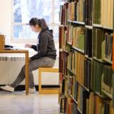 Student reading a book in Norlin Library