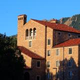 Building on campus with Flatirons in the background